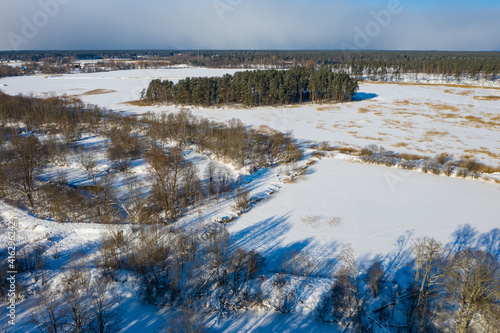 Scenic winter landscape. Top drone view. Forest and snow. Blue shadows