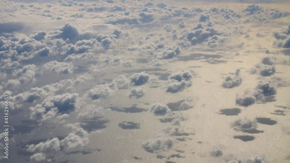Cirrocumulus clouds over golden sea at sunset view from a airplane Cirrocumulus clouds over golden sea at sunset view from a airplane