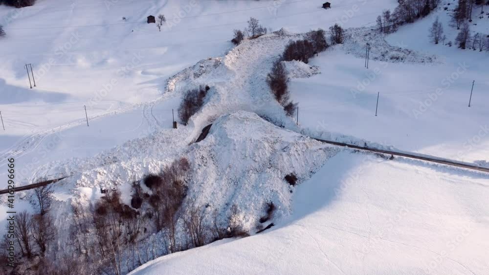 Aerial view of a snow avalanche burying the road to the village in Grengiols in 2021. Cut off from the outside world. The road has been cleared again. Large masses of snow
