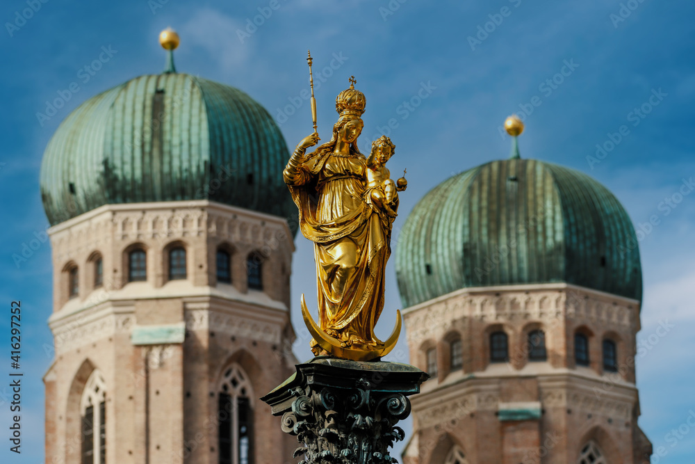 Golden Marian Column  at Marienplatz in bright sunlight in front of Marienkirchen in Munich