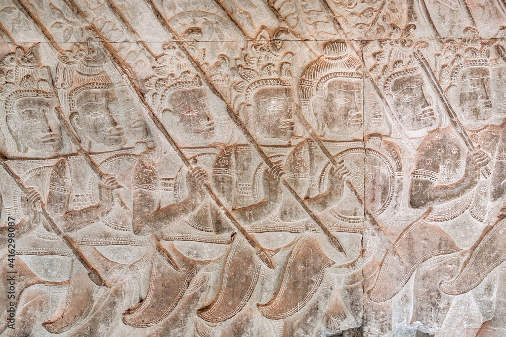 Historical army with spears on reliefs of Angkor Wat temple, 12th century Khmer landmark. Cambodian complex and UNESCO World Heritage Site