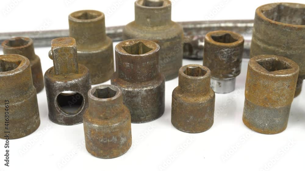 Socket heads, tools for loosening and tightening nuts. Old wrenches covered with rust. Dolly shot on white isolated. Socket heads, tools for loosening and tightening nuts. Old wrenches covered with rust. Dolly shot on white isolated.