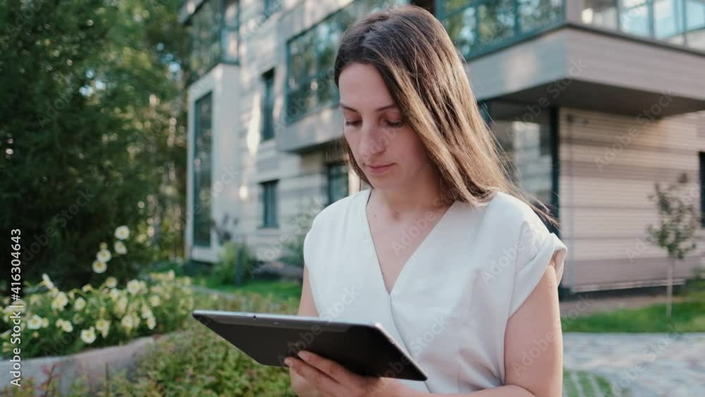 Young business woman who surfs the internet on a tablet outdoors Young business woman who surfs the internet on a tablet outdoors