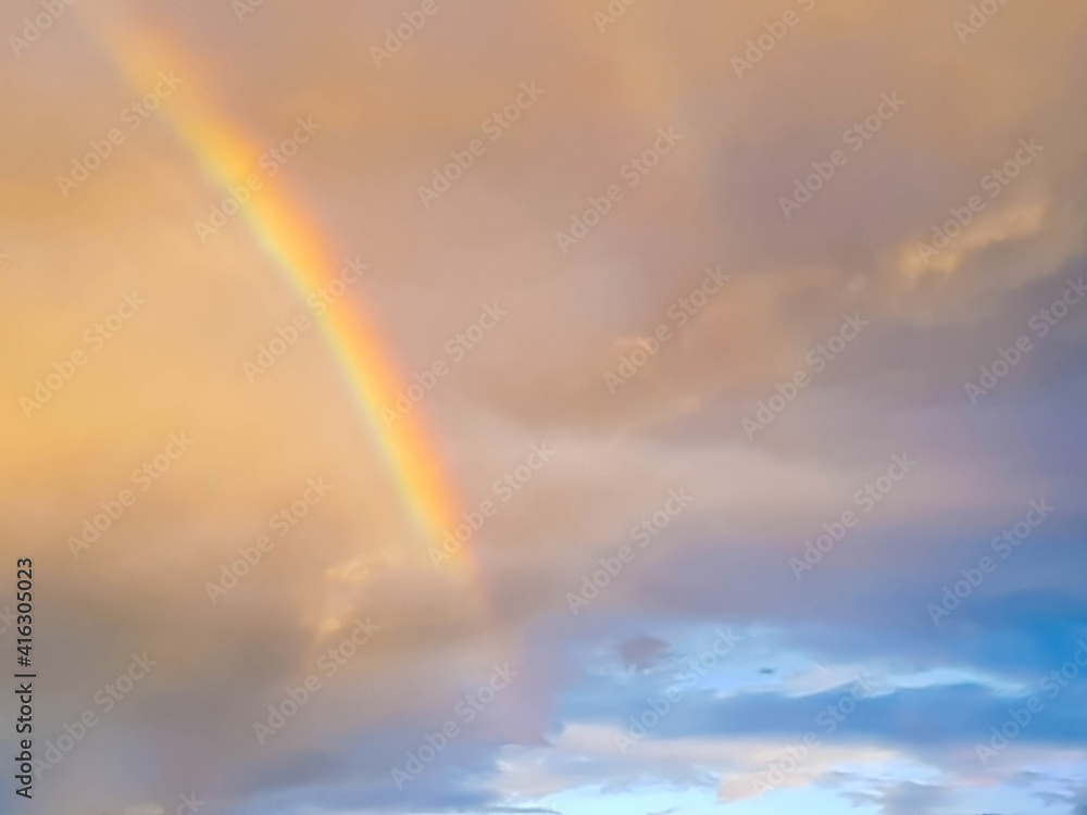 detail of rainbow arch in sunset sky and clouds 