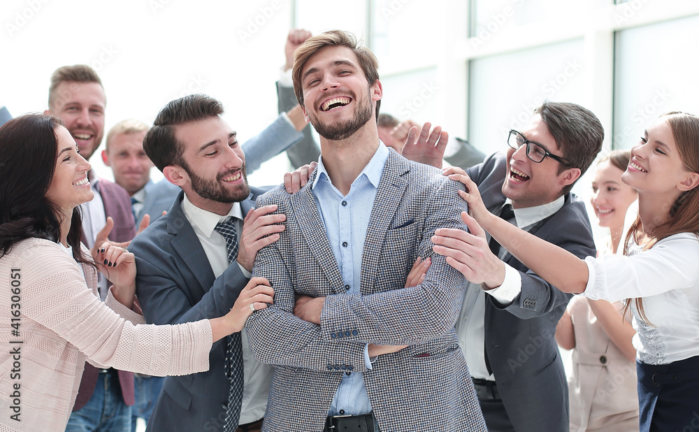 © ASDF - smiling entrepreneur on the background of jubilant business team © ASDF - smiling entrepreneur on the background of jubilant business team