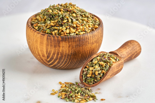 Mixed spice zaatar or zatar in wooden bowl . Closeup photo