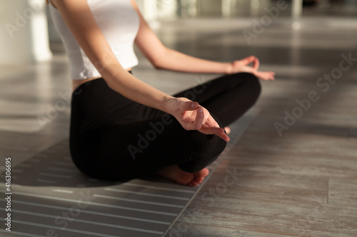 a woman with a slim figure is engaged in yoga in the hall 