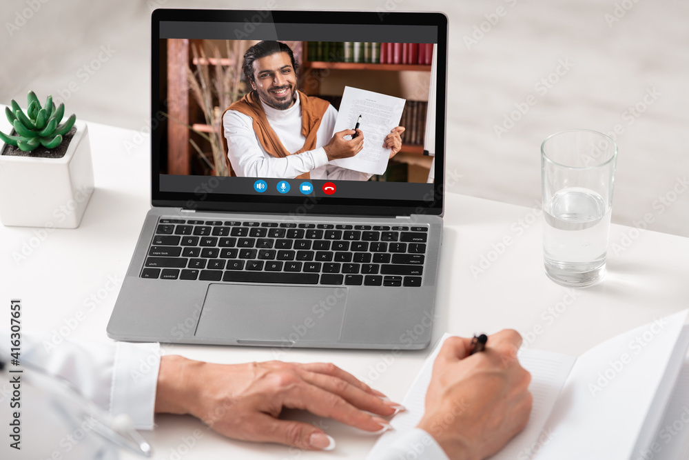 Unrecognizable woman having online lesson, using laptop Unrecognizable woman having online lesson, using laptop