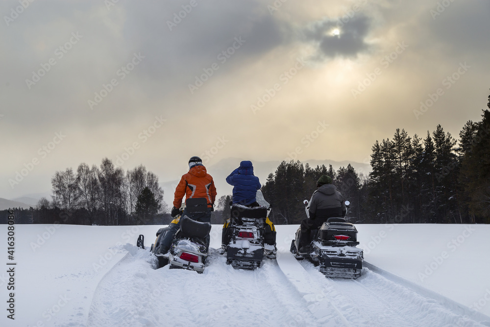 Athletes on a snowmobiles.