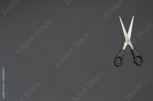 black scissors on black background