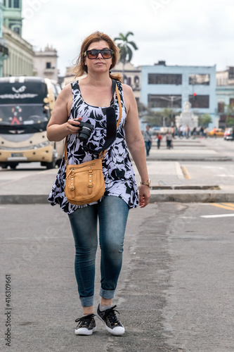 Photography A Hispanic middle-aged woman doing tourism in Havana, Cuba