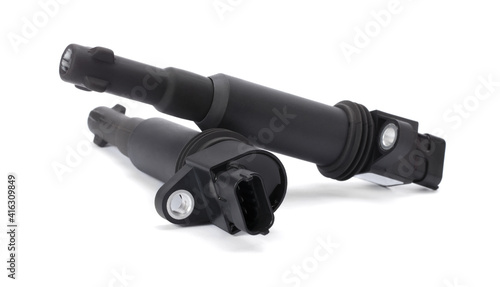 Fotografie Two black ignition coils (or spark coil) of ignition system of gasoline engine isolated on white background