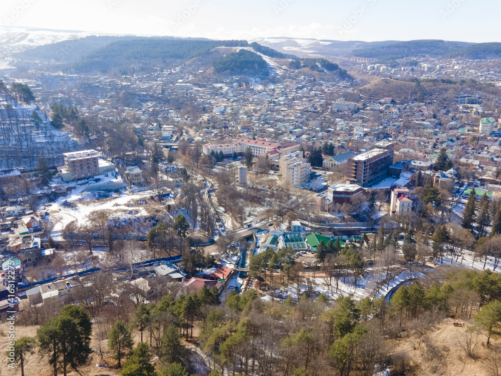 Aerial view of Kislovodsk in winter, cityscape with mountains in the background
