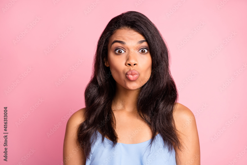 Portrait of optimistic brunette lady blow kiss wear blue top isolated on pastel pink color background Portrait of optimistic brunette lady blow kiss wear blue top isolated on pastel pink color background