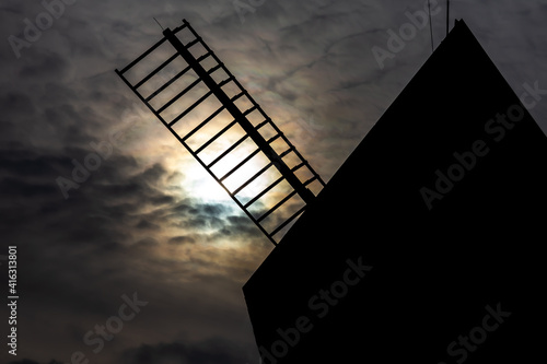 Wooden windmill in a rural open-air museum. Taken in the middle of the day, exposition set to pretend night seassion. photo