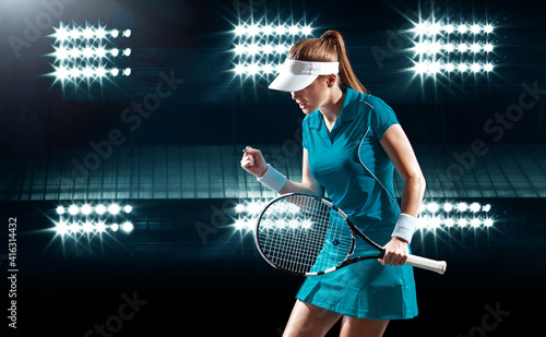 Tennis player with racket. Woman athlete celebrating victory on grand arena background after good play. © Mike Orlov