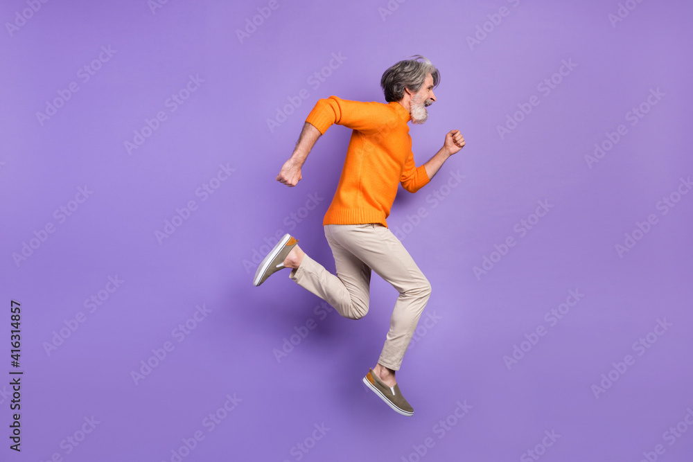 Full size profile side photo of mature man go walk run jump hurry sale isolated over purple color background