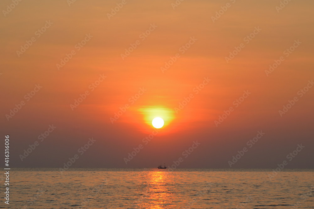 Sunrise over the sea with fishing boat in the morning. Thailand.