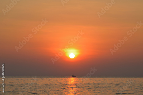 Sunrise over the sea with fishing boat in the morning. Thailand.