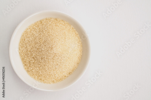 view from above on bowl filled with brown sugar on white table