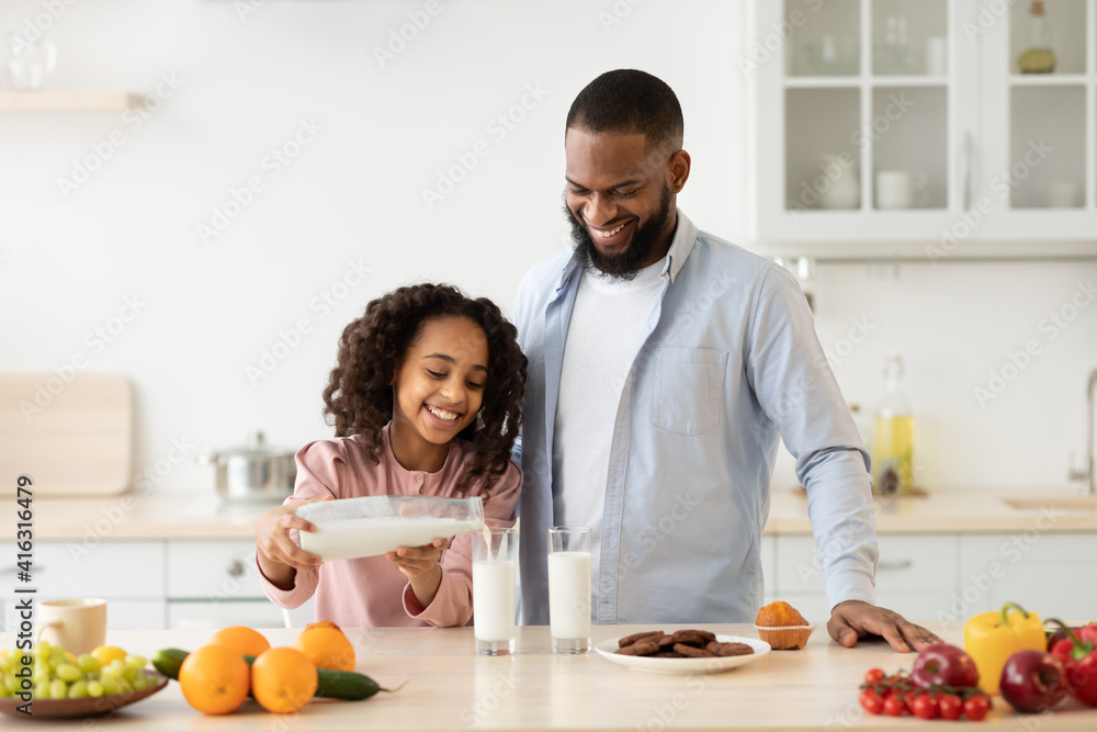 Little Afro Girl And Her Handsome Dad Pouring Milk