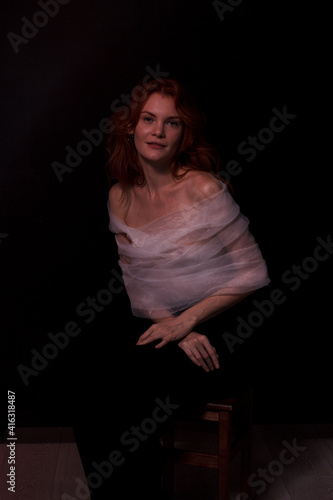 portrait of a ginger woman in white top