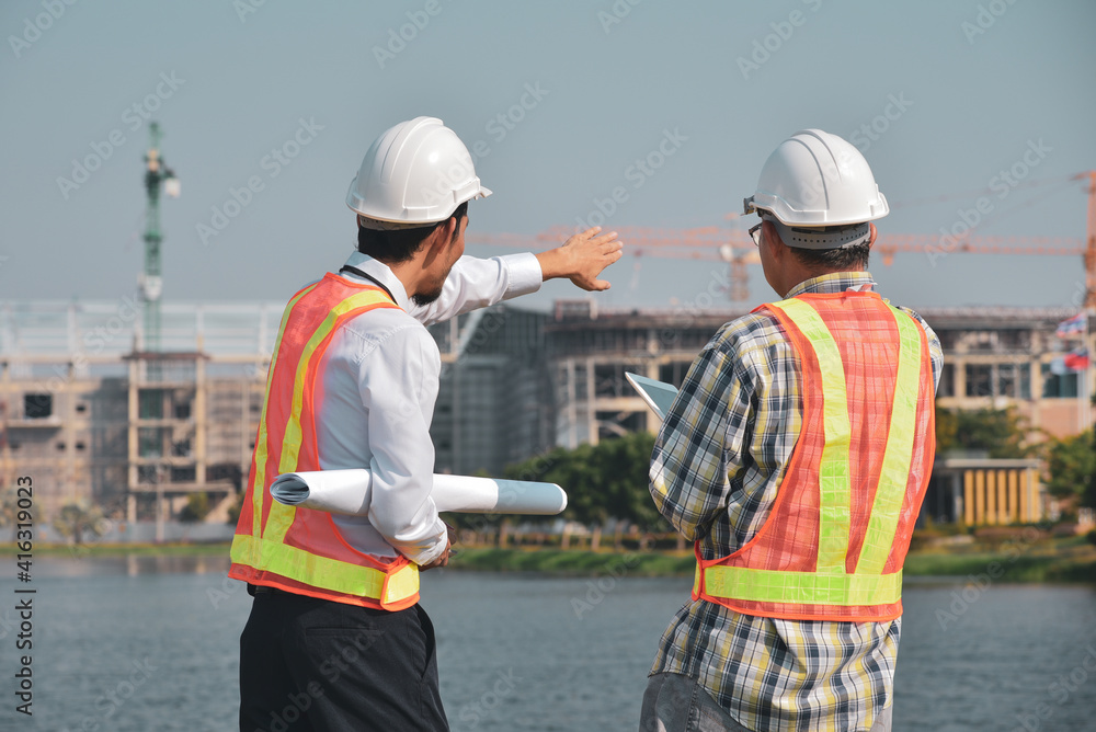 Construction engineer standing in a conversation on the building construction site