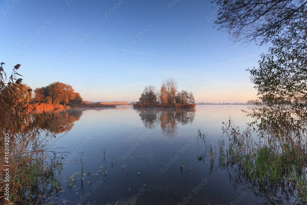 island in the lake in autumn colors
