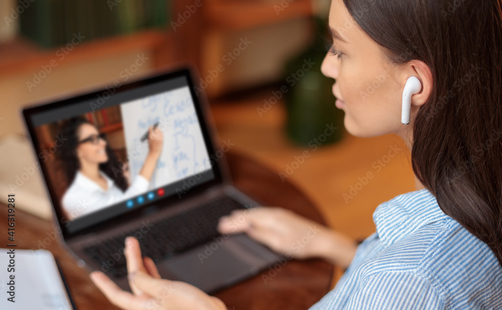 Lady using laptop for studying online, talking to teacher Lady using laptop for studying online, talking to teacher