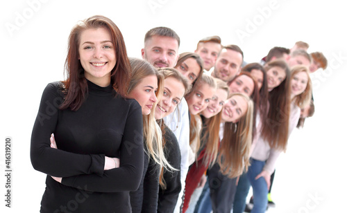 confident guy standing first in the column of young people photo