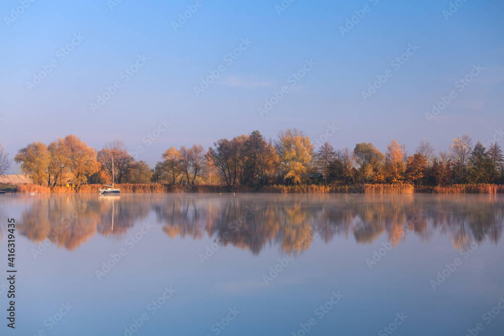 Obraz na płótnie drzewa odbijające się w jeziorze, jesienny poranek w salonie