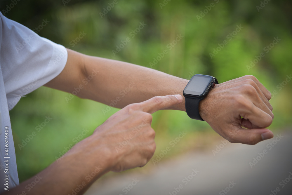 Runners watching for a sports smartwatch get ready to run using wearable technology. Runners watching for a sports smartwatch get ready to run using wearable technology.