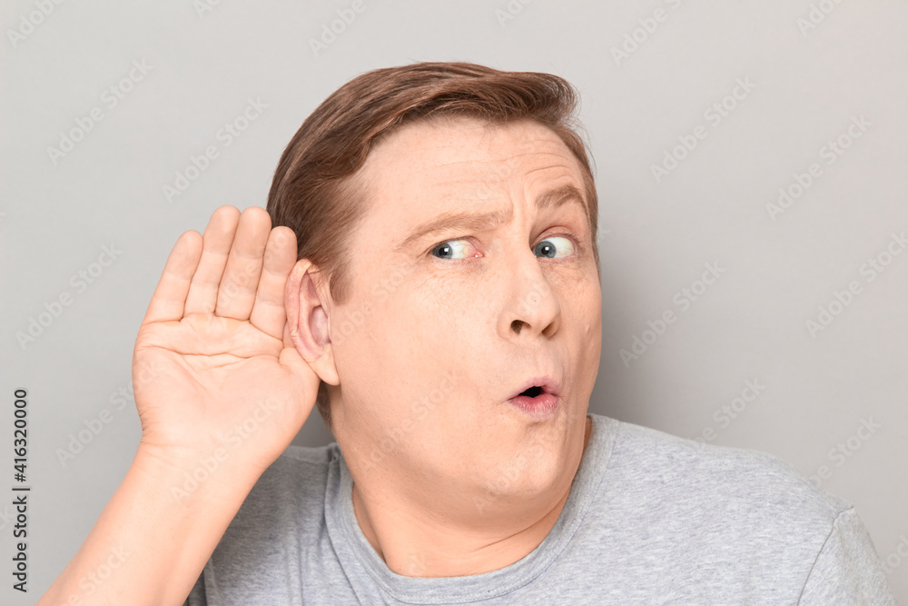 Portrait of curious man placing hand near ear and eavesdropping Portrait of curious man placing hand near ear and eavesdropping