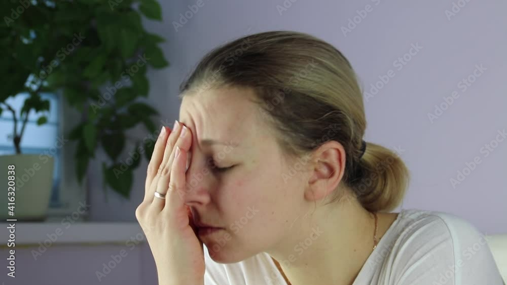 Headache. Close-up woman hands touches her forehead , experiences pain in head. Hypertension, fatigue, stress concept Headache. Close-up woman hands touches her forehead , experiences pain in head. Hypertension, fatigue, stress concept