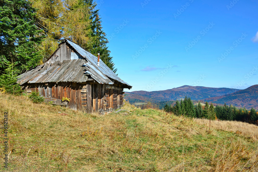 Old wooden hut in the autumn meadow, Gorce mountains, Poland Old wooden hut in the autumn meadow, Gorce mountains, Poland