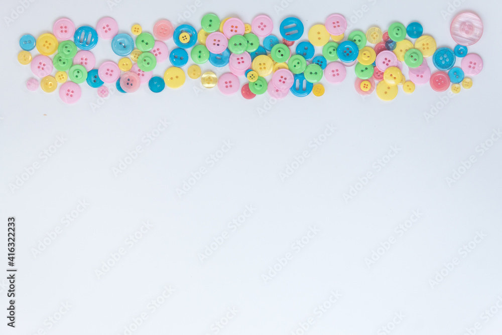Colored buttons located at the top on a white background. A place for text. Green, blue, yellow, pink buttons.