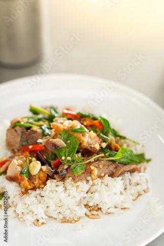 Top view, Stir-fried Thai basil with meat and basils sort in a white dish. Copy space