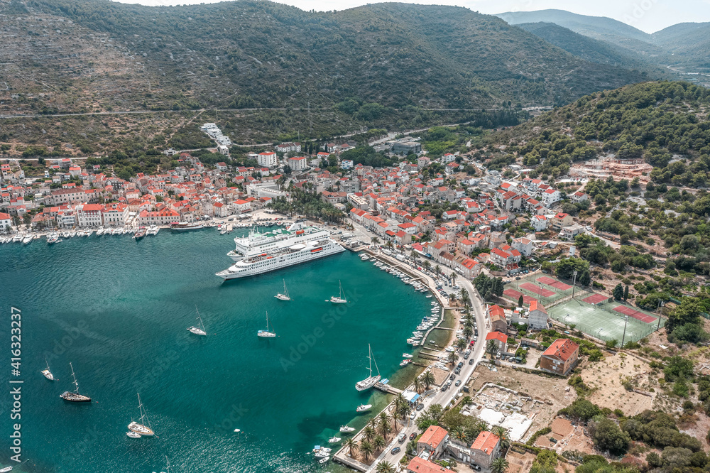 Aerial drone shot of cruise ferry at Adriatic sea port on Vis Island in Croatia summer