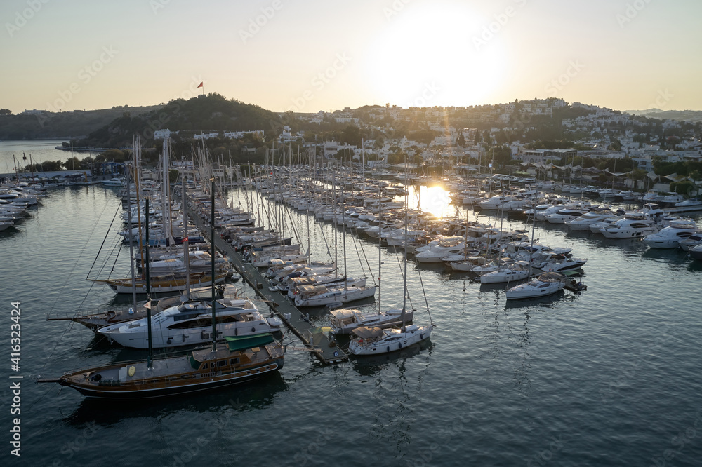 View of beautiful harbor and boats at sunset. Picturesque view of the port of Bodrum with the sailing boats at Turkey.