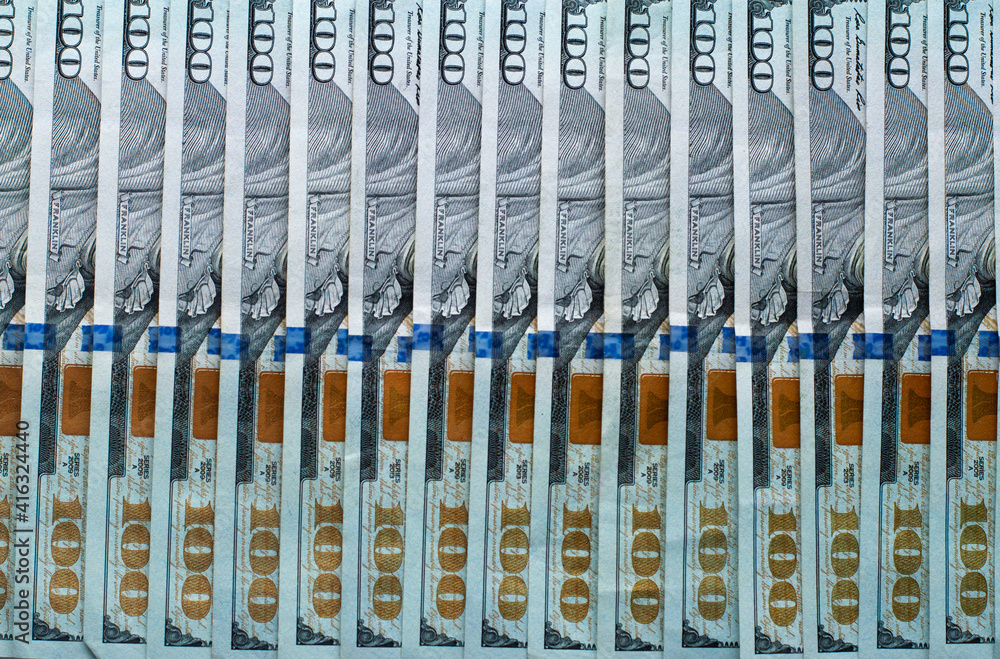 Evenly laid out in a row hundred dollar bills. Evenly laid out in a row hundred dollar bills.