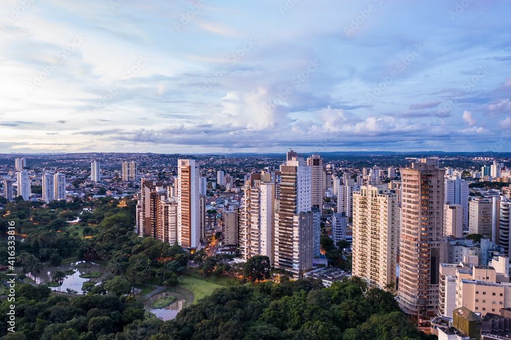 Obraz premium Parque Zoologico de Goiânia near lake das rosas, Goiás, Brazil, residential buildings in the background, bluish evening