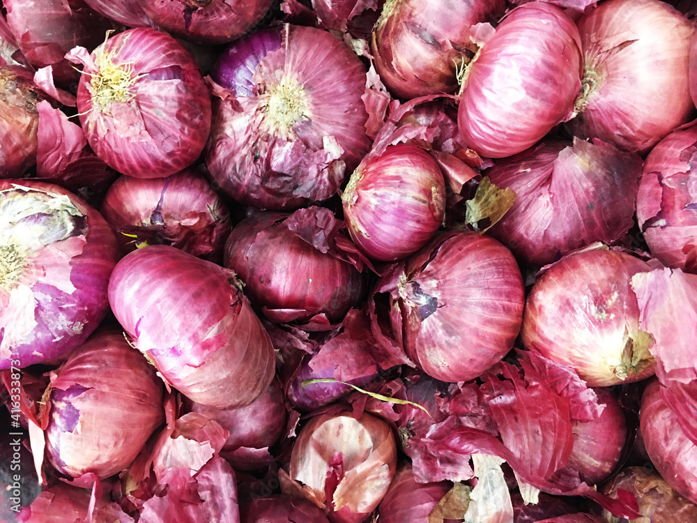 Red onions in plenty on display at local farmer's market, Big fresh red onions background