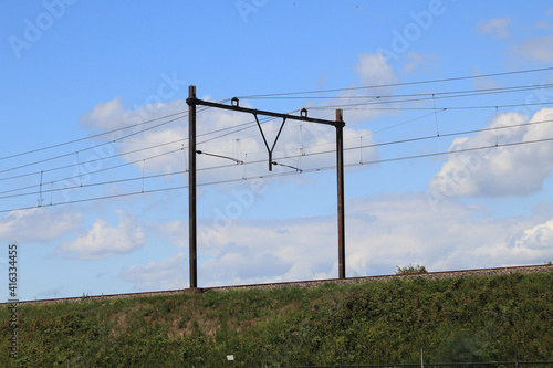 Embankment with catenary, blue sky in the background 