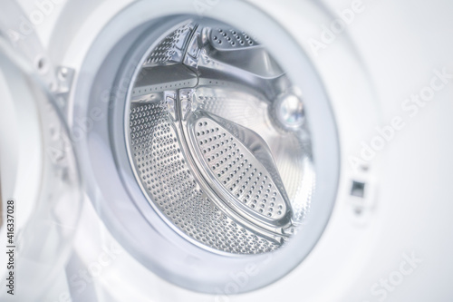 open door of an empty washing machine close up