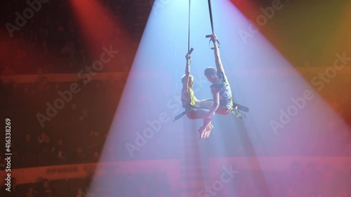 Two young aerialists on canvases in circus