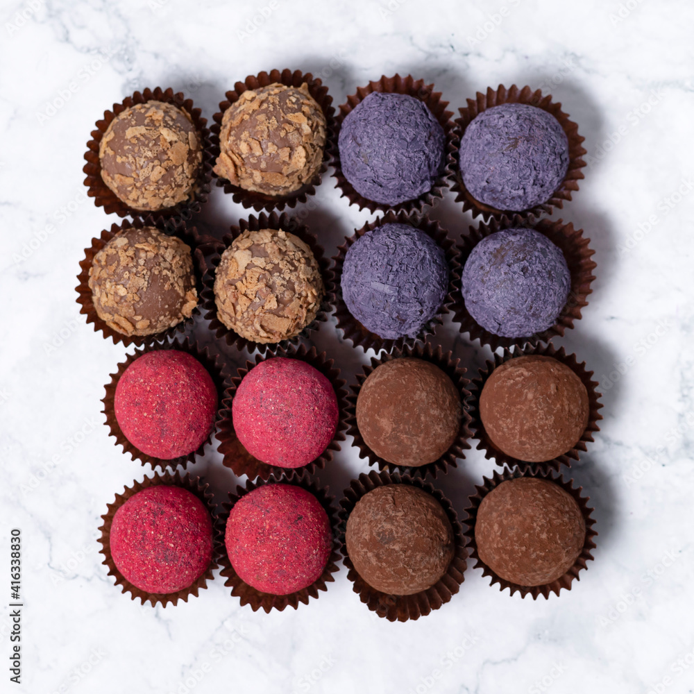 colored homemade energy balls - truffles made of cocoa, blueberry and beetroot powder colored homemade energy balls - truffles made of cocoa, blueberry and beetroot powder