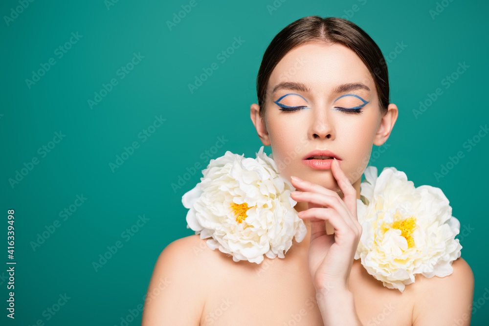 sensual woman with closed eyes and white peonies on shoulders touching lips isolated on green sensual woman with closed eyes and white peonies on shoulders touching lips isolated on green