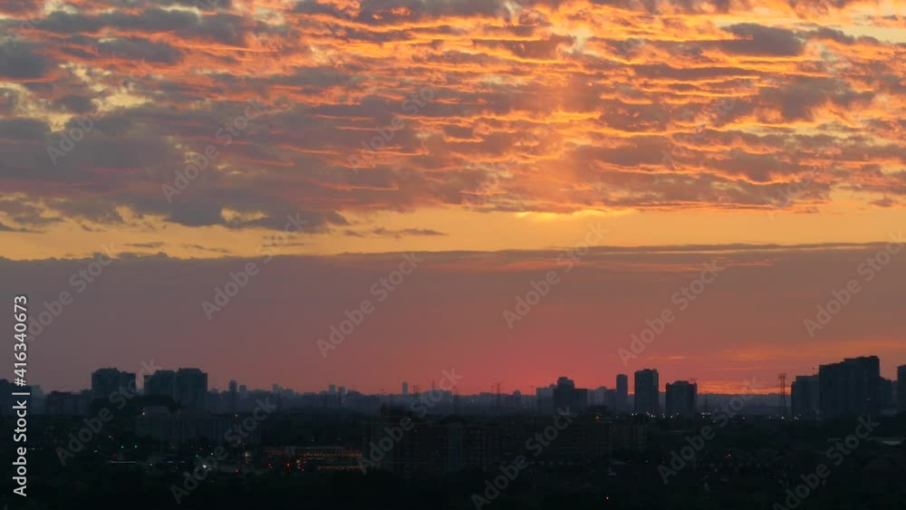 stunning sunset with beautiful clouds in the sky forming interesting patterns and silhouettes of buildings on the horizon stunning sunset with beautiful clouds in the sky forming interesting patterns and silhouettes of buildings on the horizon