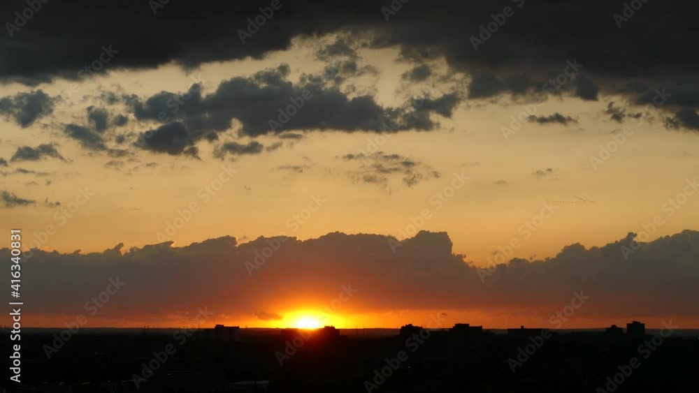 Imposing sunset with clouds passing through the sky and beautiful golden tones Imposing sunset with clouds passing through the sky and beautiful golden tones