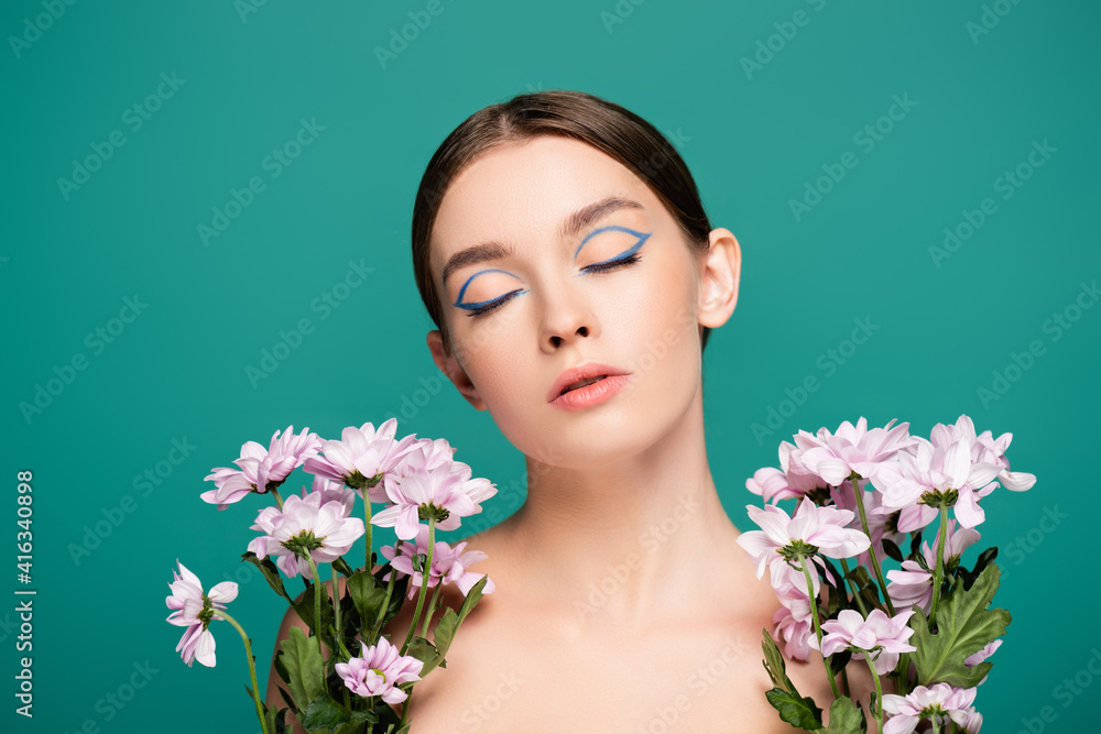 sensual woman with closed eyes near pink chrysanthemums isolated on green sensual woman with closed eyes near pink chrysanthemums isolated on green